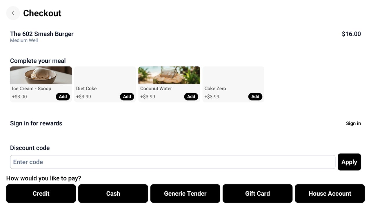 NX Kiosk checkout screen with add-on suggestions, rewards sign-in, a discount code field, and payment options.